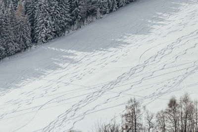 Scenic view of snow covered land against sky