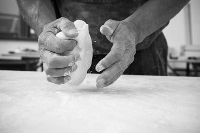 Man holding ice cream cone on table