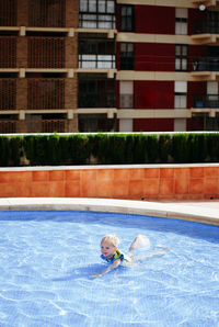 High angle view of girl swimming in pool