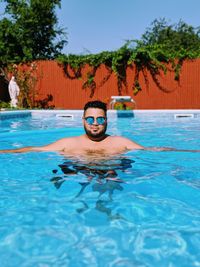 Portrait of shirtless man in swimming pool