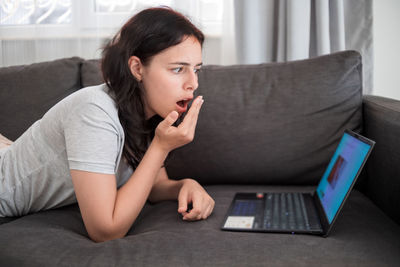 Young woman using laptop at home