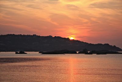 Scenic view of sea against romantic sky at sunset
