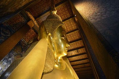 Low angle view of golden buddha statue in temple
