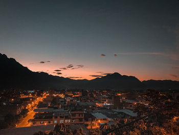 Aerial view of townscape against sky at sunset