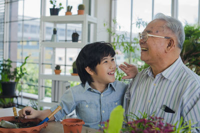 Happy boy with arms raised outdoors