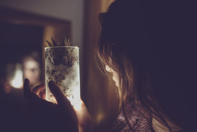 Woman holding pineapple drink in glass