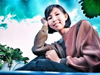 Portrait of boy sitting on swimming pool