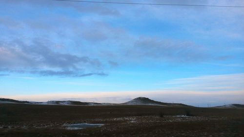 Scenic view of landscape against blue sky