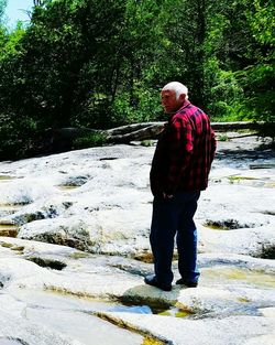 Full length of man standing on riverbank