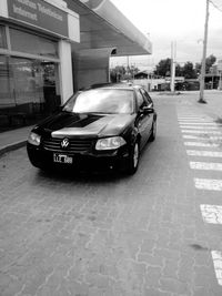 Car on street against buildings in city