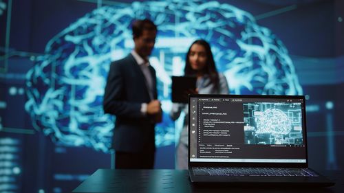 Digital composite image of businessman using laptop at office