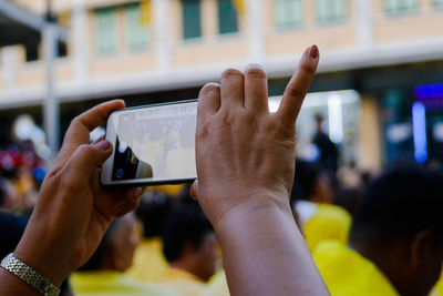 Cropped hands of woman photographing