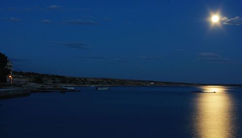 Scenic view of sea against sky at night