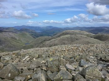 Scenic view of mountains against cloudy sky