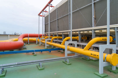 View of industry by swimming pool against sky