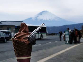 Close-up of ice cream against snowcapped mountain