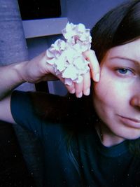 Close-up portrait of a girl with pink flower