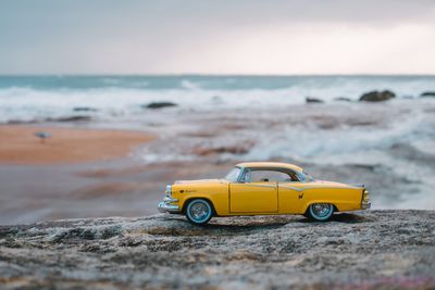 Close-up of toy car on beach