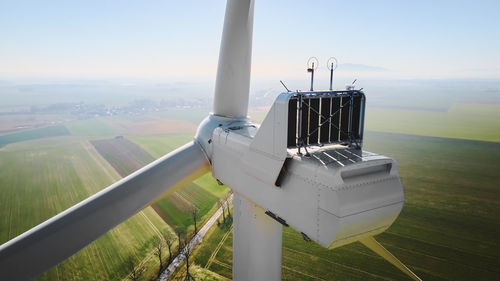 Aerial view of part of windmill turbine in countryside, green energy