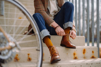 Low section of man standing on street