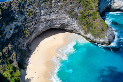 High angle view of rocks on sea shore