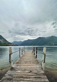 Pier over lake against sky