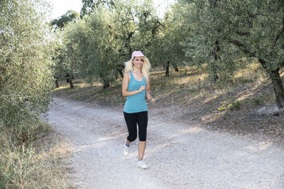 Portrait of young woman standing on road