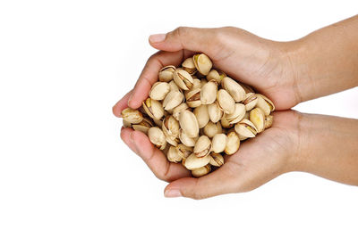 Midsection of person holding ice cream against white background