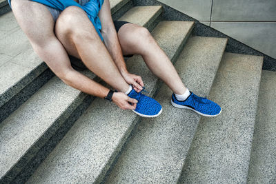 Low section of man sitting on staircase