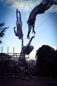 Low angle view of statue against sky