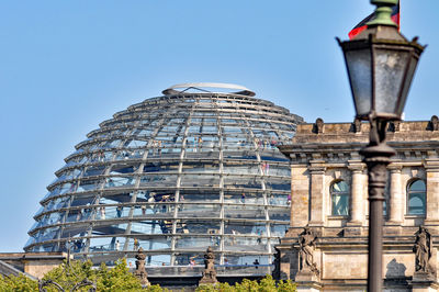 Low angle view of reichstag dome against blue sky