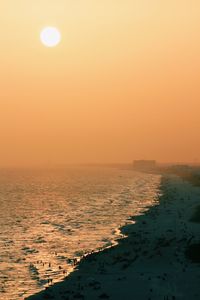 Scenic view of sea against clear sky during sunset