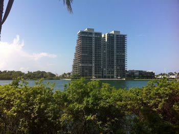 Scenic view of sea by buildings against clear sky