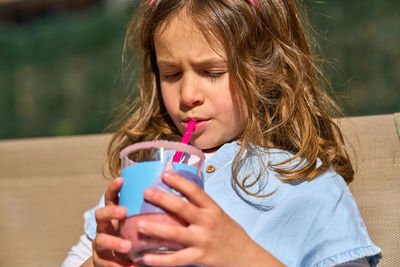 Girl drinking juice in glass