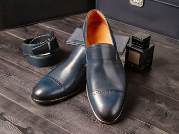 High angle view of shoes on wooden table