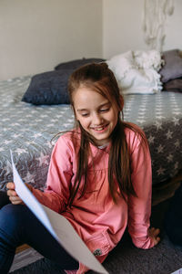 Portrait of young woman sitting on sofa at home