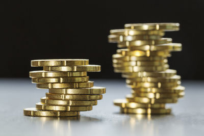 Close-up of coin stack against black background