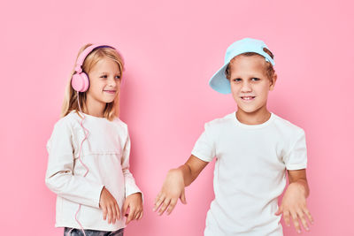 Portrait of smiling friends standing against white background