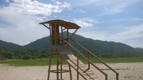 Traditional windmill on field against sky