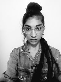 Portrait of beautiful young woman against white background