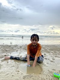 Portrait of boy sitting on beach
