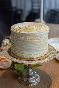 Single tier wedding cake decorated in buttercream ruffles.