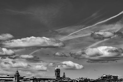 Low angle view of buildings against cloudy sky