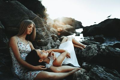 Young woman sitting on rock