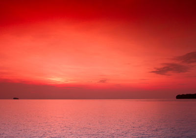 Scenic view of sea against romantic sky at sunset