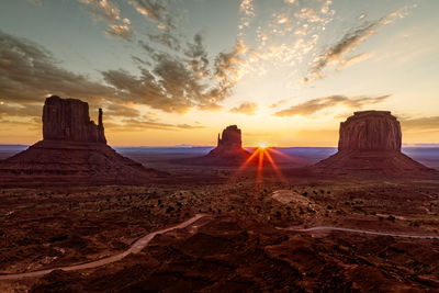 Scenic view of rock formations against sky during sunset