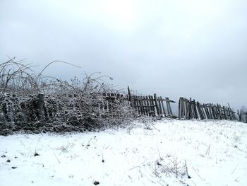 Snow covered field against sky