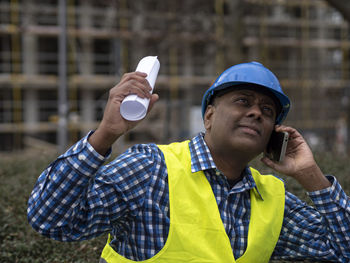 Portrait of young man drinking water bottle