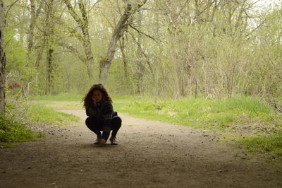Woman crouching on field