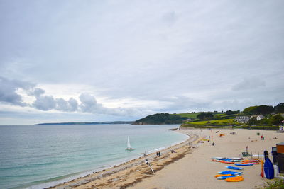 Panoramic view of people on beach against sky